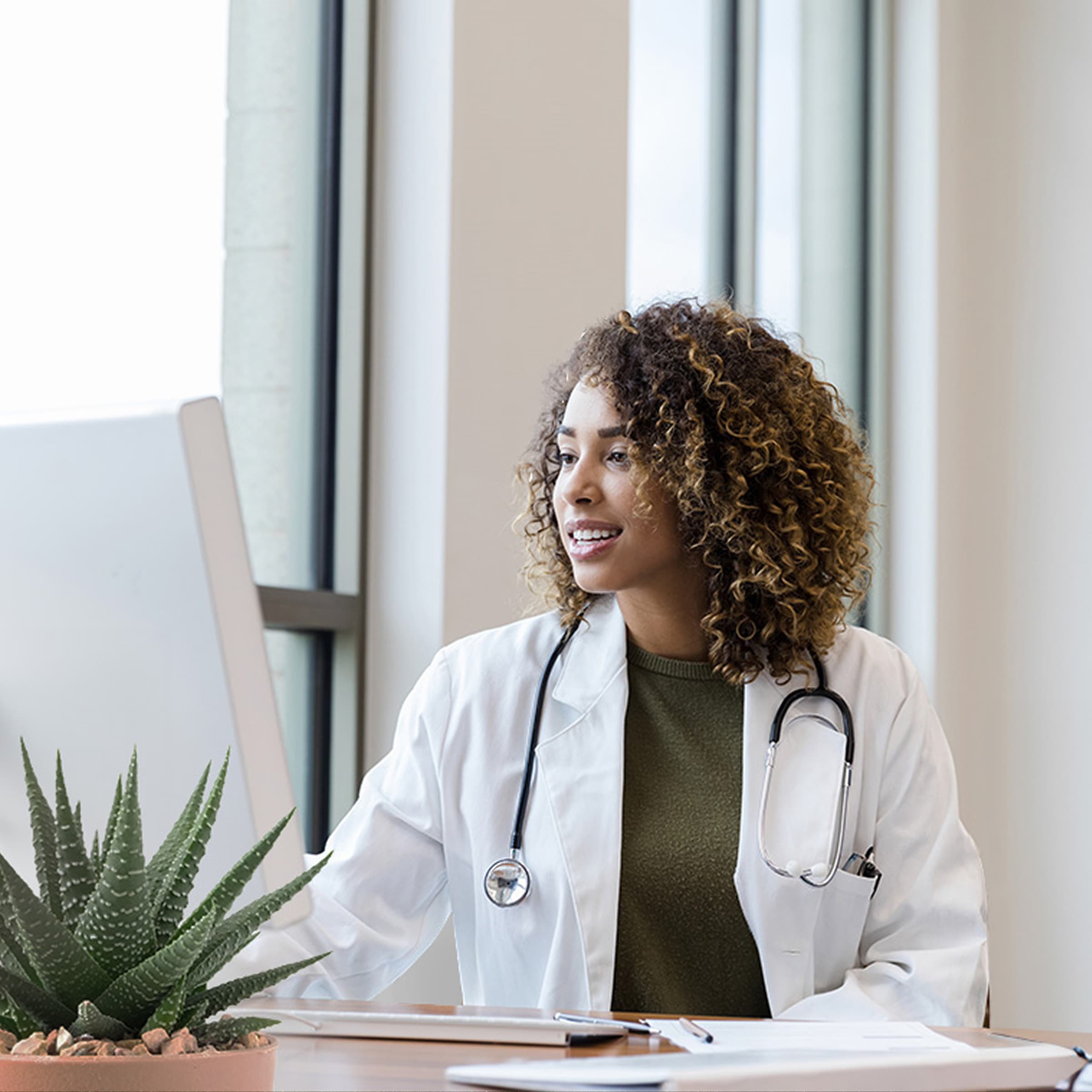 Veterinarian sitting at her workstation